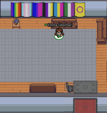 Screenshot of a topdown RPG game that shows an avatar of "Emma (she/her)" standing in front of several pride flags